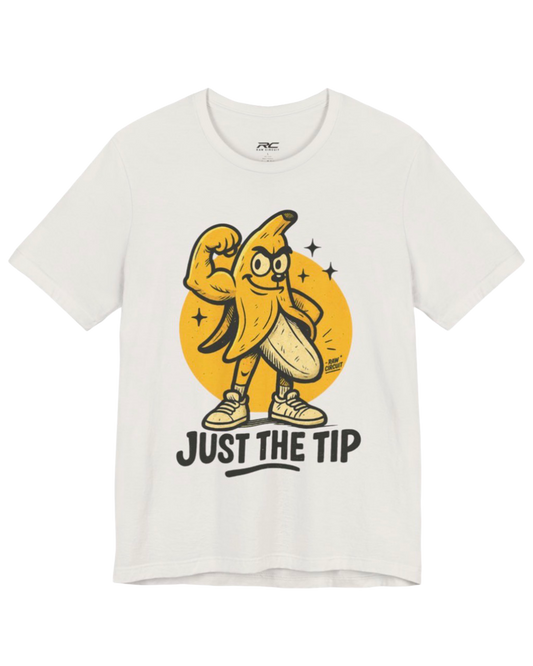 RAW CIRCUIT Just the Tip graphic tee in vintage white, featuring a playful flexing cartoon banana wearing sneakers, a yellow circular backdrop, and bold JUST THE TIP typography.