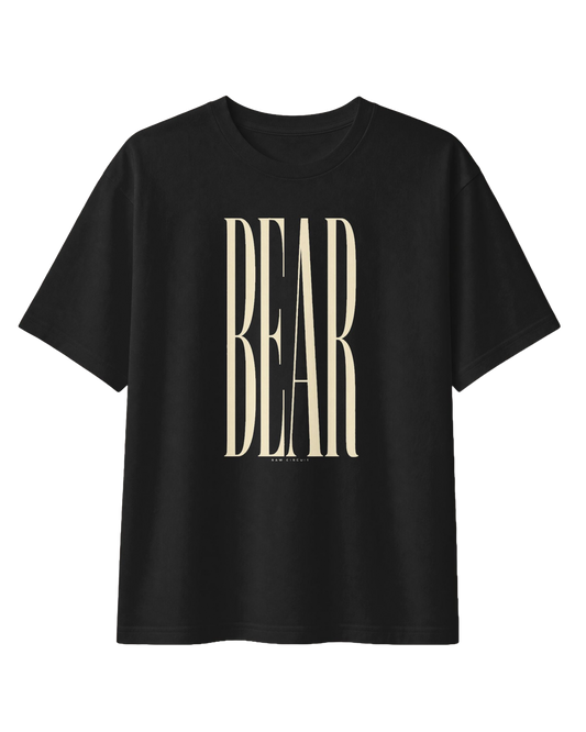 Front view of the RAW CIRCUIT BEAR graphic tee in black, featuring oversized, vertically stretched ivory serif lettering centered on the chest, with a small RAW CIRCUIT signature beneath the design.