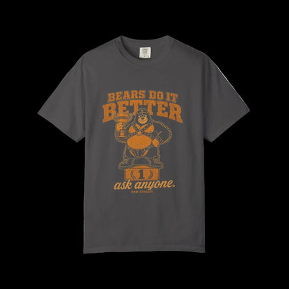 Vintage leather bear mascot standing on a winner's podium holding a trophy labeled Obviously beneath Bears Do It Better typography on graphite shirt.